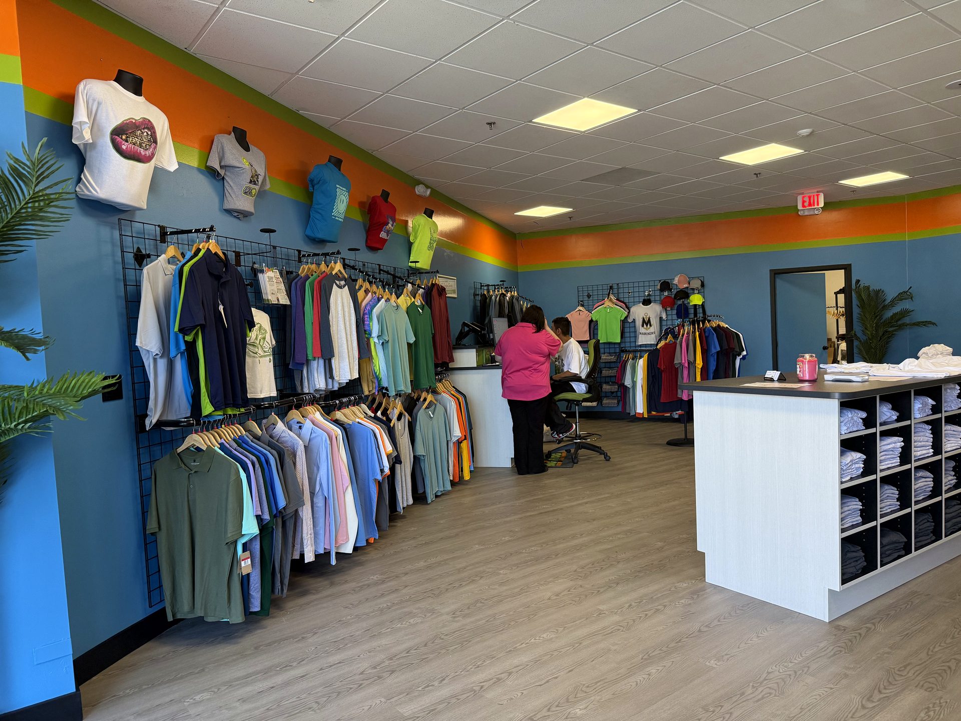 Open retail sales floor with central display island and branded feature wall, Santa Monica retail buildout by ASEP Contractors