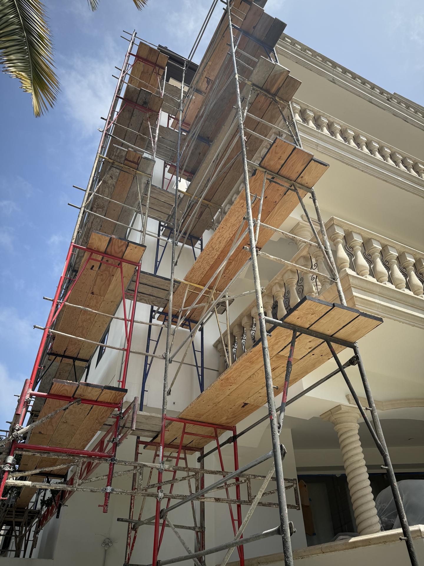 Multi-story exterior scaffolding spanning the building façade during construction at Chenault Ave
