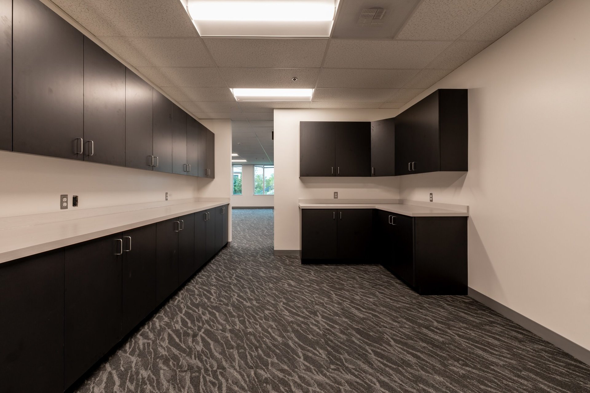 Finished break room with custom cabinetry and quartz counters, Loudoun County office renovation by ASEP Contractors
