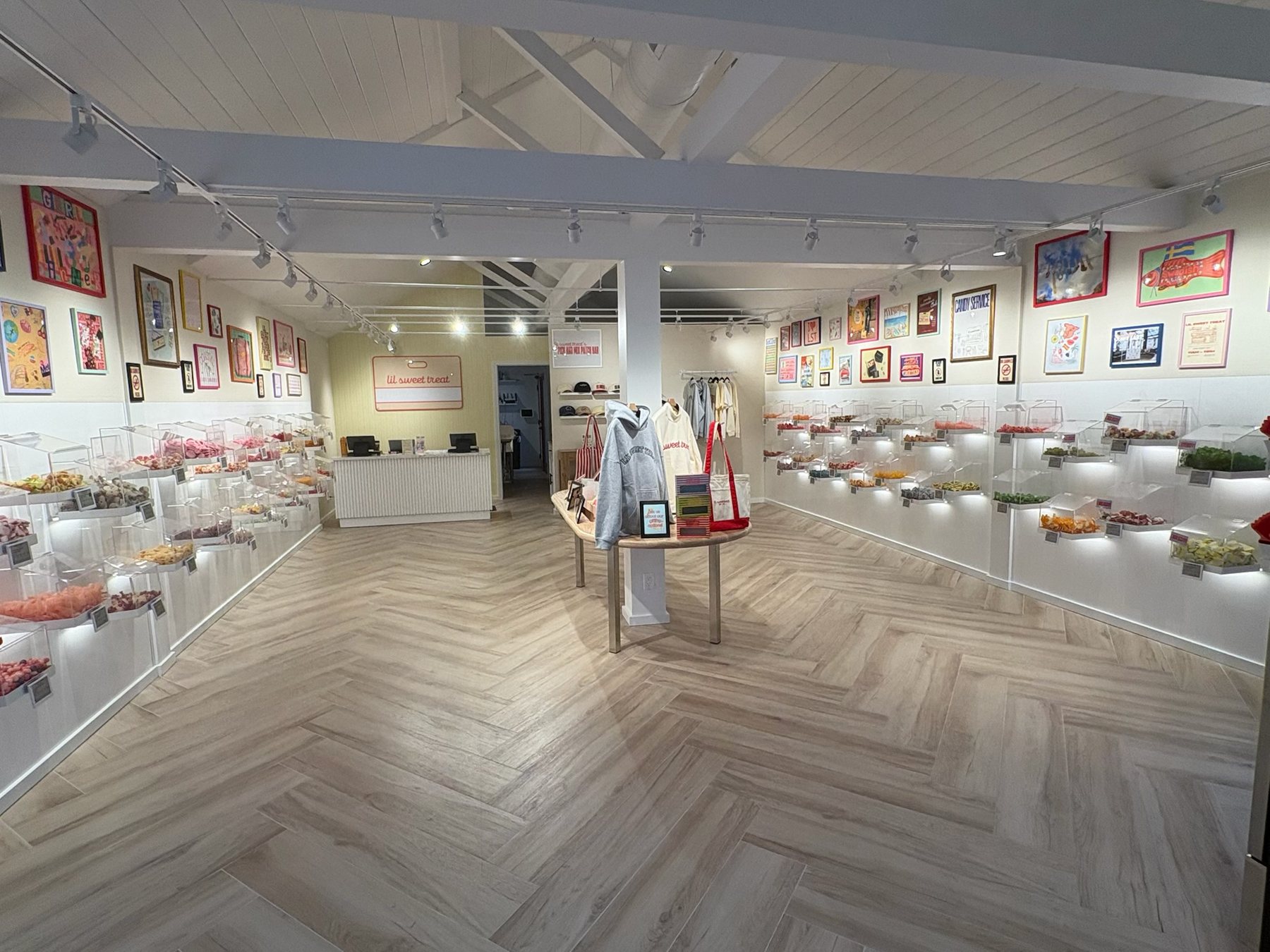 Finished candy shop interior with herringbone floor and lit display bins