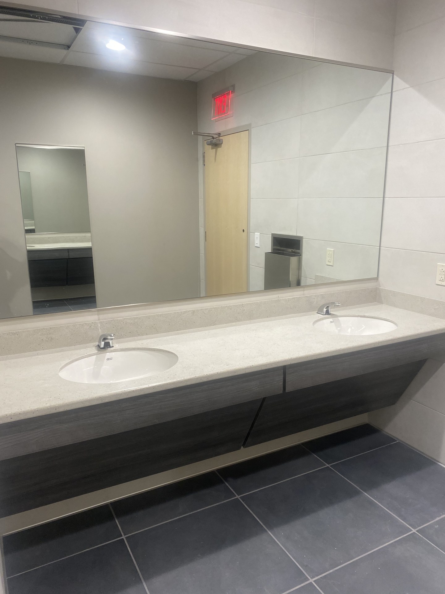 Restroom vanity with double sinks and mirror