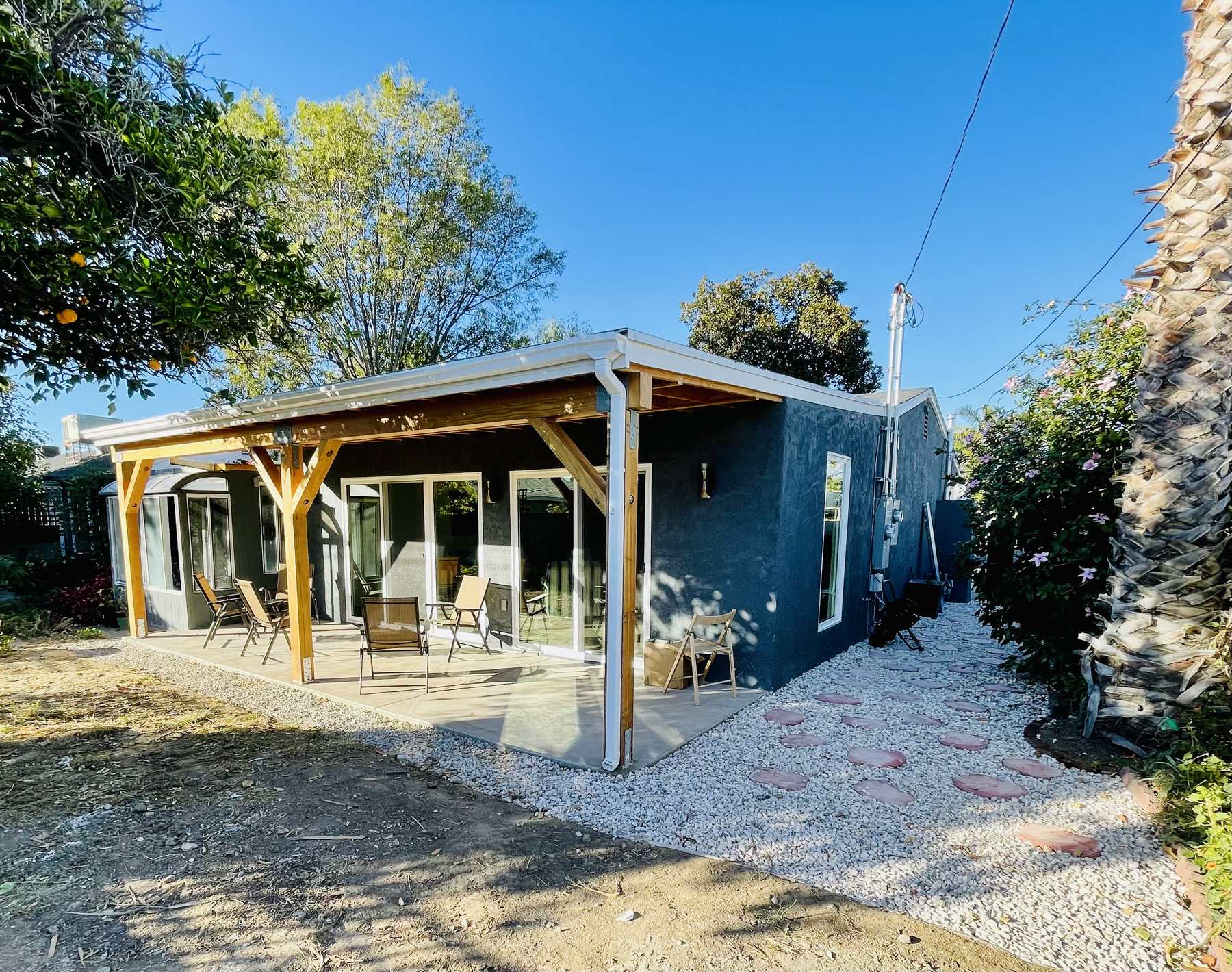 Renovated residential exterior with covered patio