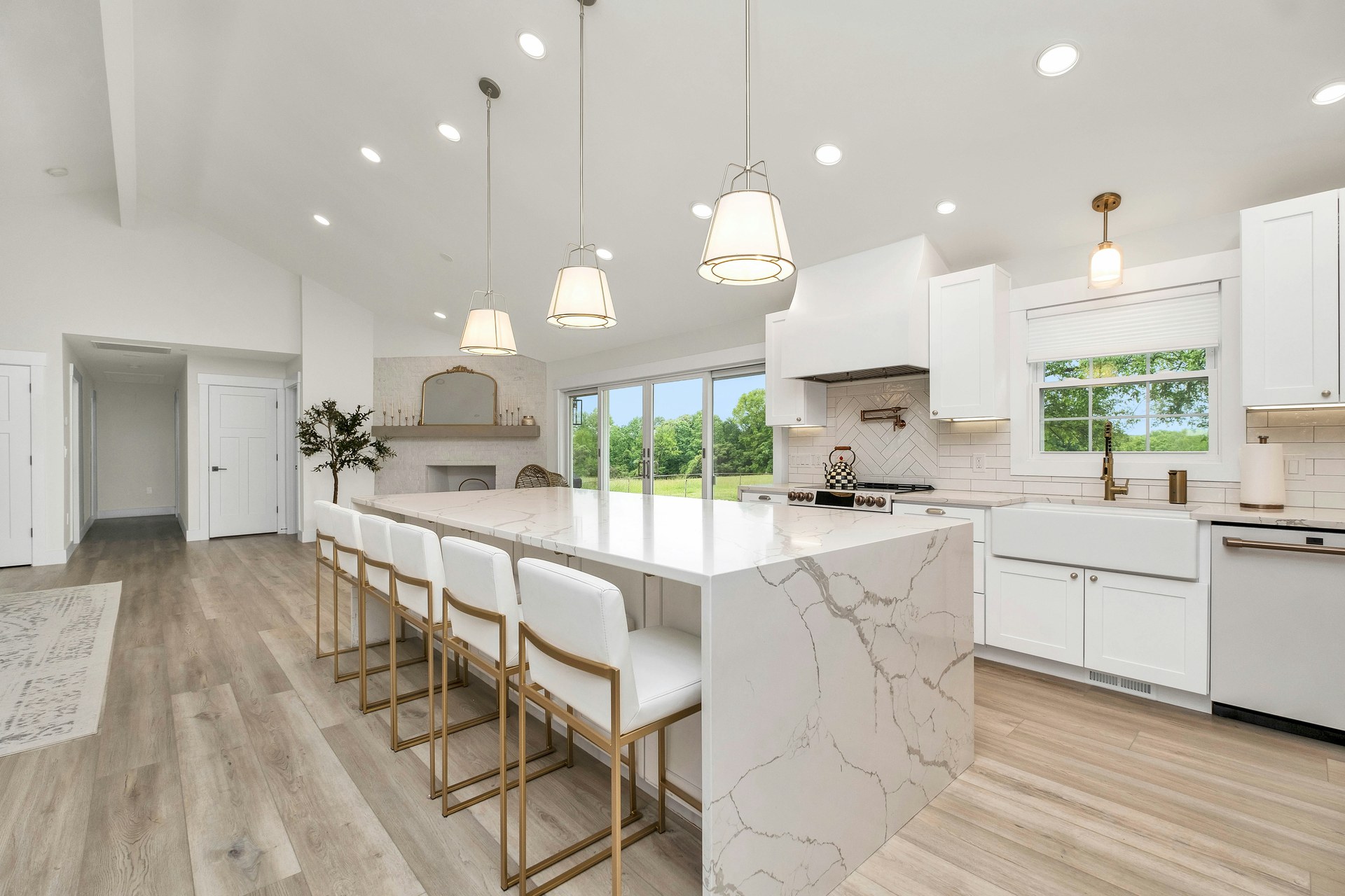 Modern white kitchen with marble waterfall island — residential renovation by ASEP Contractors