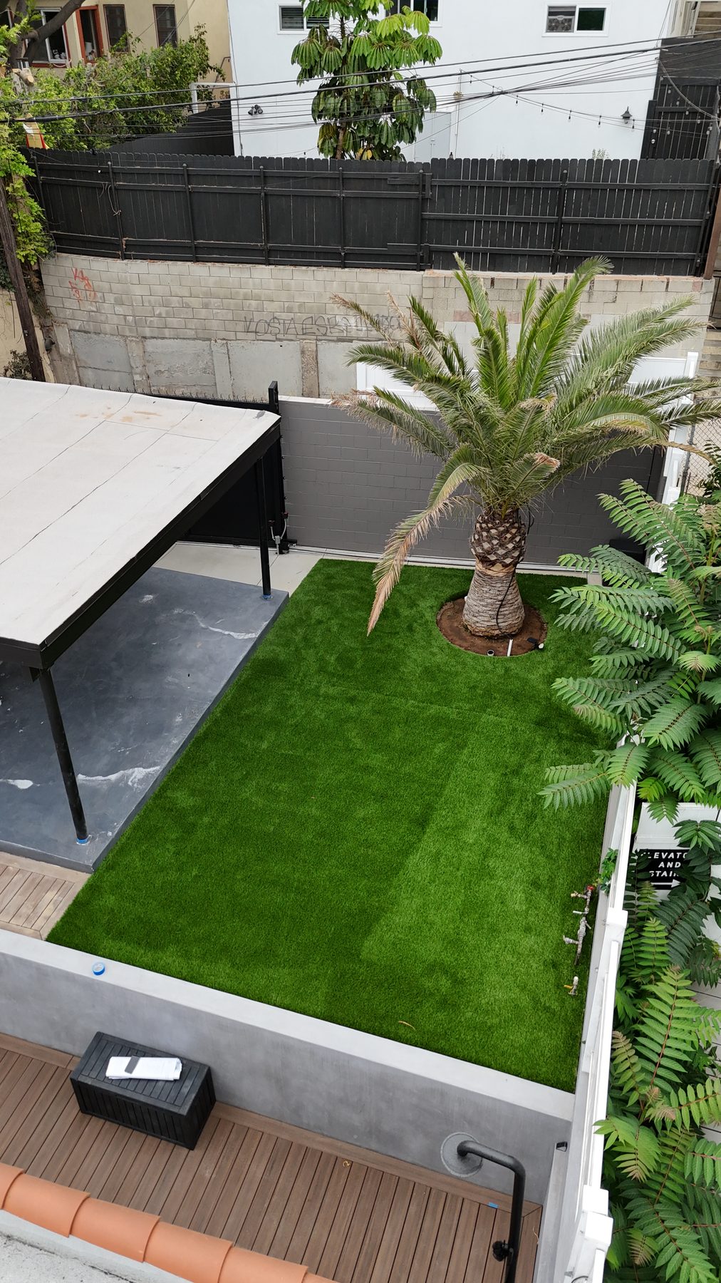 Landscaped backyard with composite deck and turf