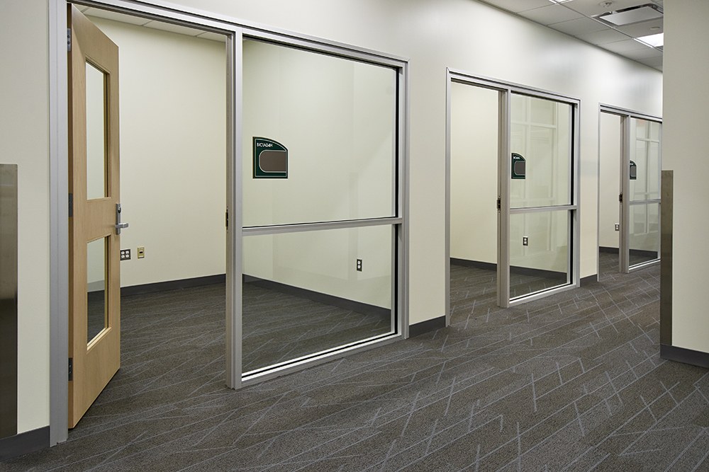 Corridor of glazed office fronts in a Sherman Oaks office tenant improvement by ASEP Contractors