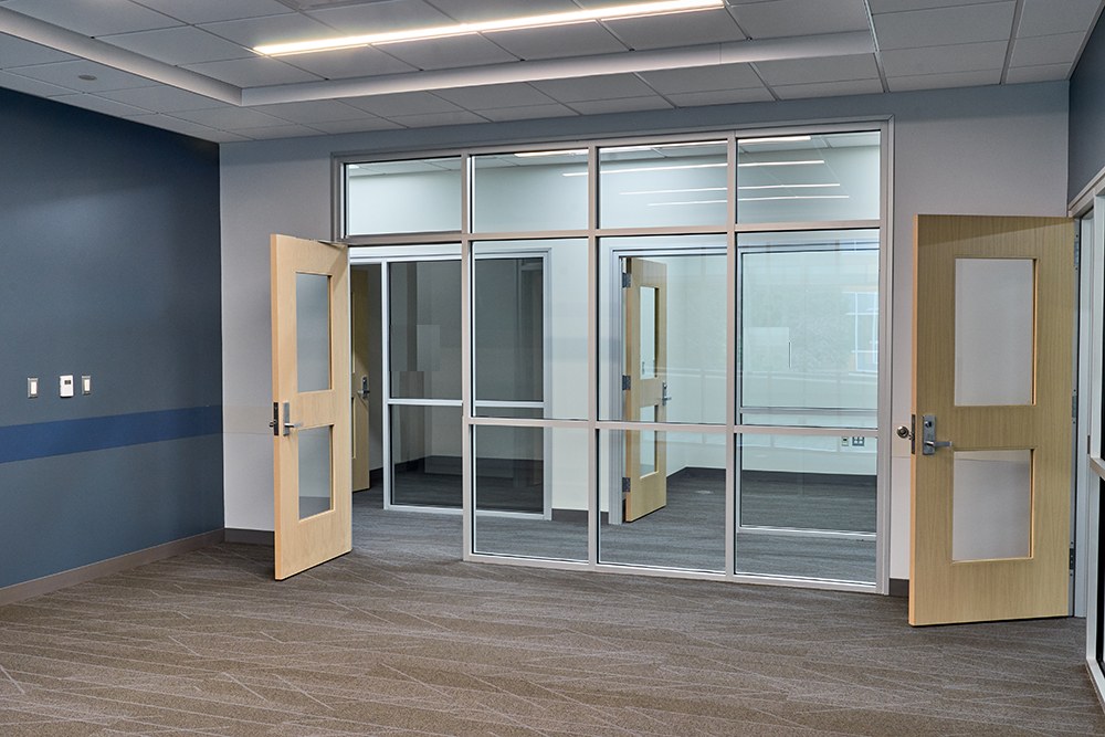 Glass-fronted private offices with storefront framing and wood doors, Sherman Oaks office build-out by ASEP Contractors