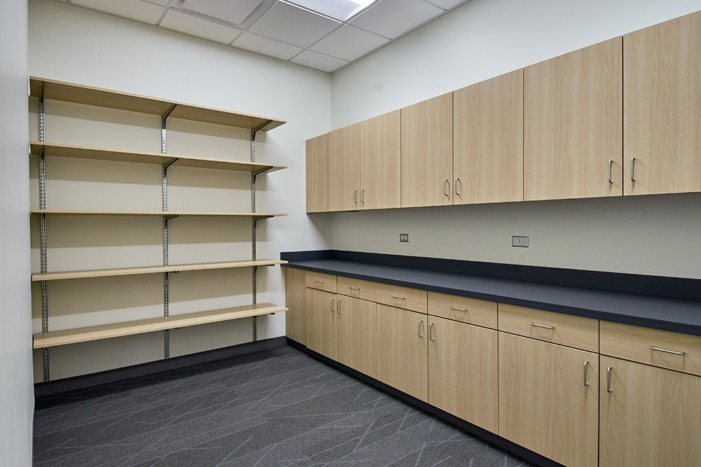 Custom millwork storage and work room with cabinetry and shelving, Sherman Oaks office build-out by ASEP Contractors